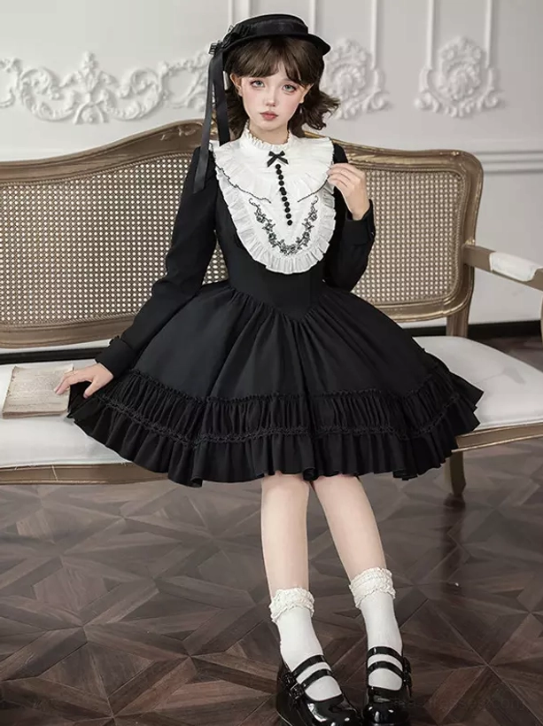Gothic Lolita dress back view showing fitted waist and cascading ruffled skirt layers, styled with white socks and Mary Jane shoes in vintage sitting room setting