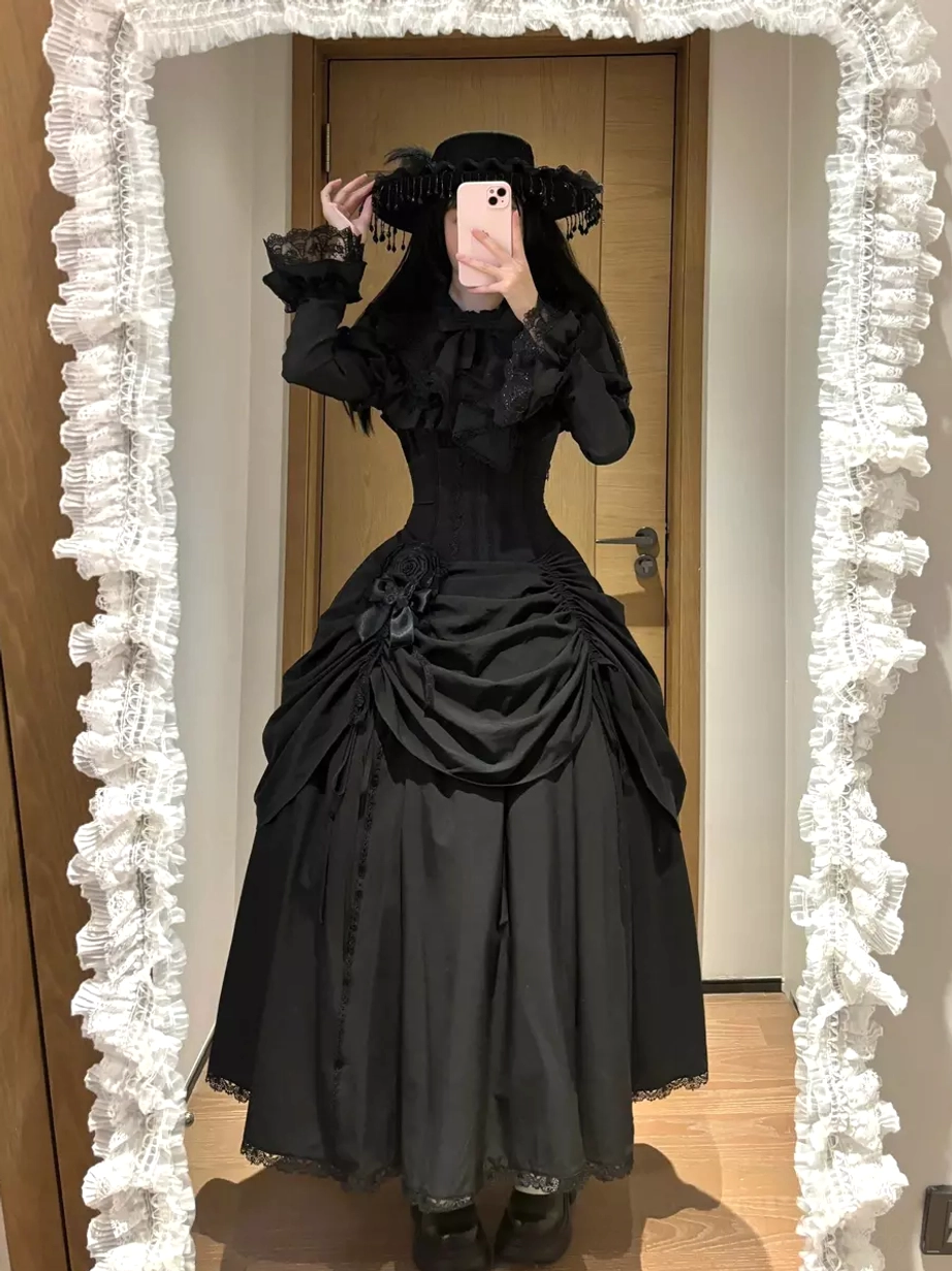 Gothic black lolita dress set indoor mirror selfie with model wearing vintage black hat, fitted bodice, and full long skirt