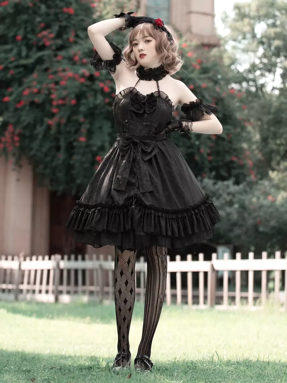 Gothic Lolita black dress full front standing view with off-shoulder ruffled sleeves and layered ruffled skirt, rose headband accessory