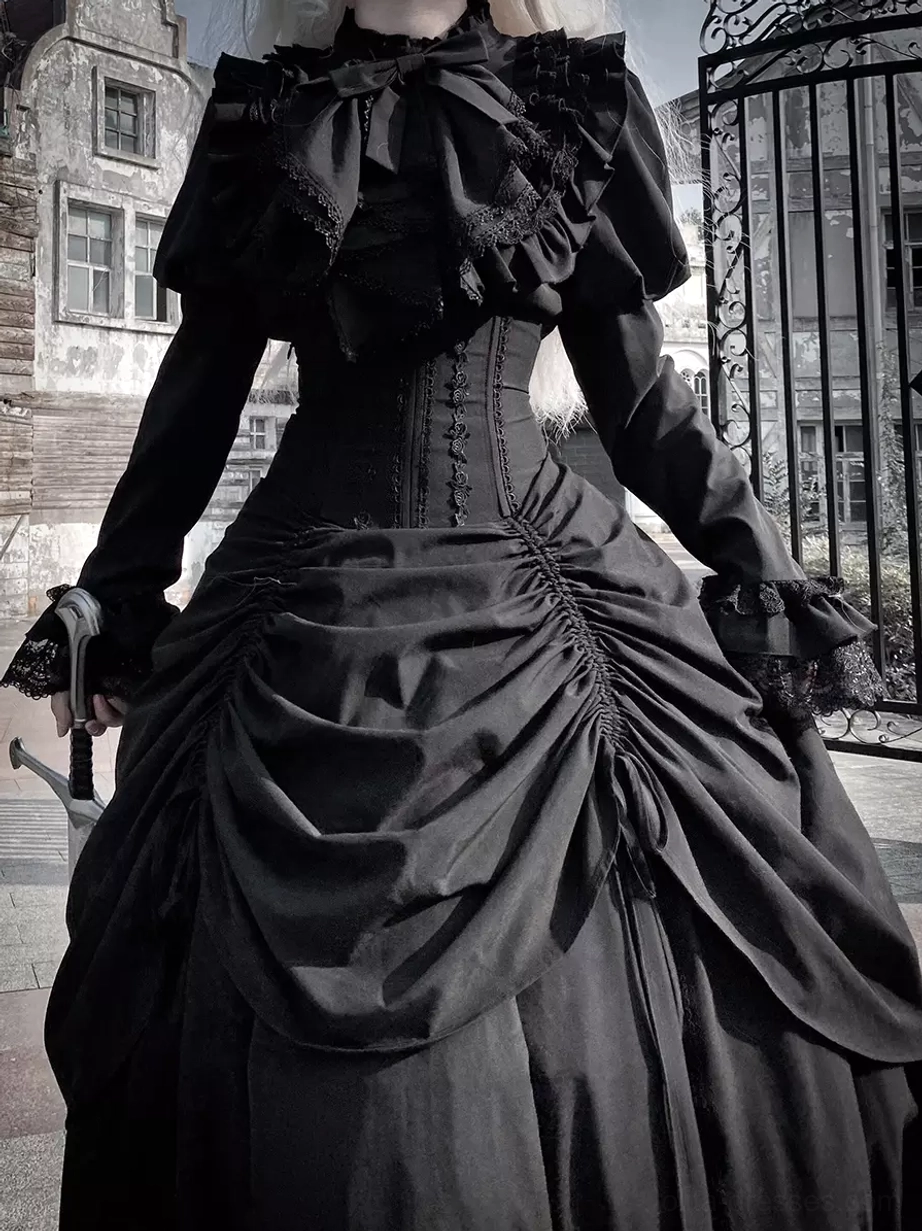 Gothic lolita dress close-up front view showing big ruffled bow collar, corset waist detail, and ruched satin skirt