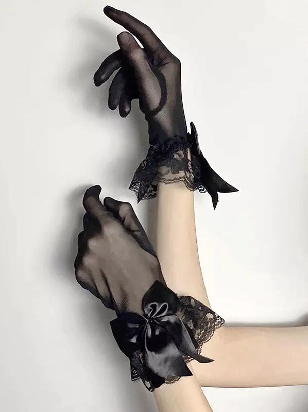 Gothic lolita oversleeves in black tulle mesh with satin wrist bows and floral lace trim, side arm view displaying drape and construction quality