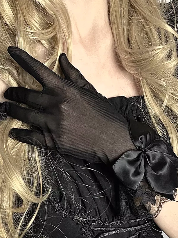Model wearing black gothic lolita gloves with goth dress, displaying how sheer mesh and satin bow complement dark aesthetic coordinates