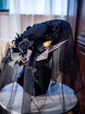 Black and gold glitter gothic lolita wide brim hat with tulle veil, rear oblique view showing full structure, mesh overlay, and decorative rose and feather accents