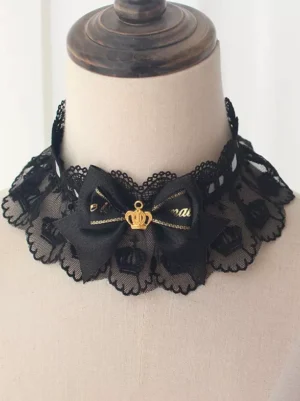Gothic lolita black scalloped lace choker with gold crown ornament and black bow embellishment front close-up on dress form