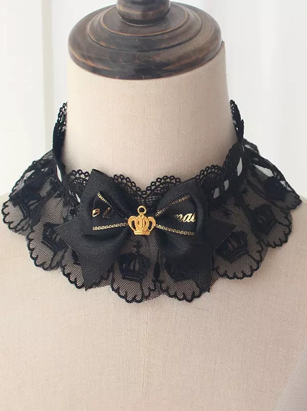 Gothic lolita black scalloped lace choker with gold crown ornament and black bow embellishment front close-up on dress form
