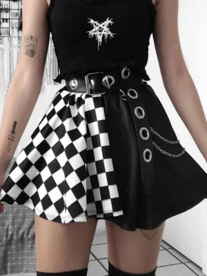 Black gothic lolita mini skirt with checkerboard and solid patchwork design, worn by model with crop top, showcasing metal grommets and chain embellishments from side angle