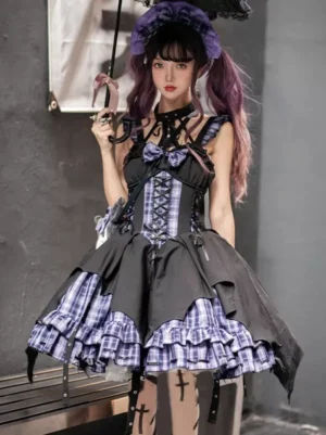 Gothic Lolita black plaid jumper dress with lace-up corset front and grommet side straps, front three-quarter view on model