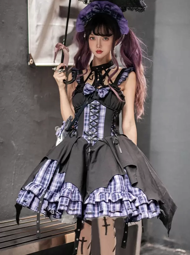 Gothic Lolita black plaid jumper dress with lace-up corset front and grommet side straps, front three-quarter view on model