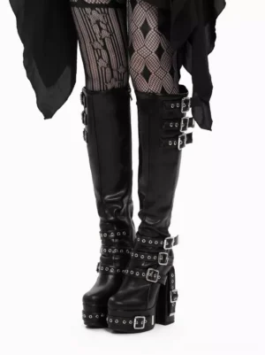 Gothic lolita platform boots with black metallic PU leather and grommet details worn with argyle fishnet tights front eye-level view both feet