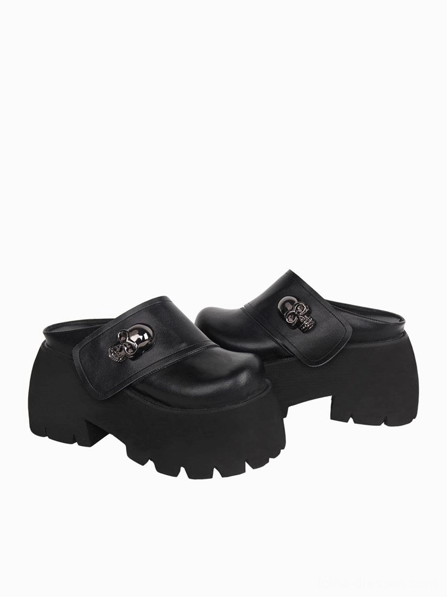 Black platform mule loafers pair front view all-black design matching silver skull decoration chunky slip-on
