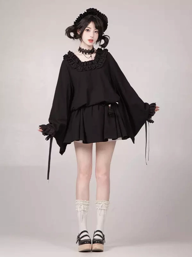 Gothic Lolita black ruffled dress with wide bell sleeves, drawstring cuffs, matching black choker, and twin-bun hairstyle styling in studio