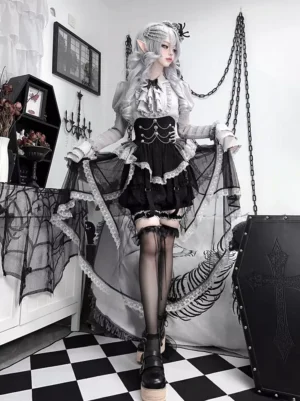 Black gothic lolita outfit side front standing view showing asymmetrical high-low tulle skirt with fishnet stockings