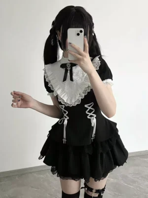 Black gothic lolita dress front view mirror selfie with dual lace-up front, color-block design, white lace ruffle collar with black bow tie, tiered skirt ruffles