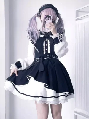 Gothic Lolita long-sleeve dress with black-white color scheme, ruffled lace hem, heart-shaped belt buckle, mirror selfie three-quarter view with model wearing light purple twin tails