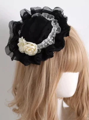 Gothic lolita mini bonnet black lace flowers pearl ribbon headdress side rear view worn on mannequin with light brown wig showing delicate black sheer ruffled trim and off-white rose embellishment