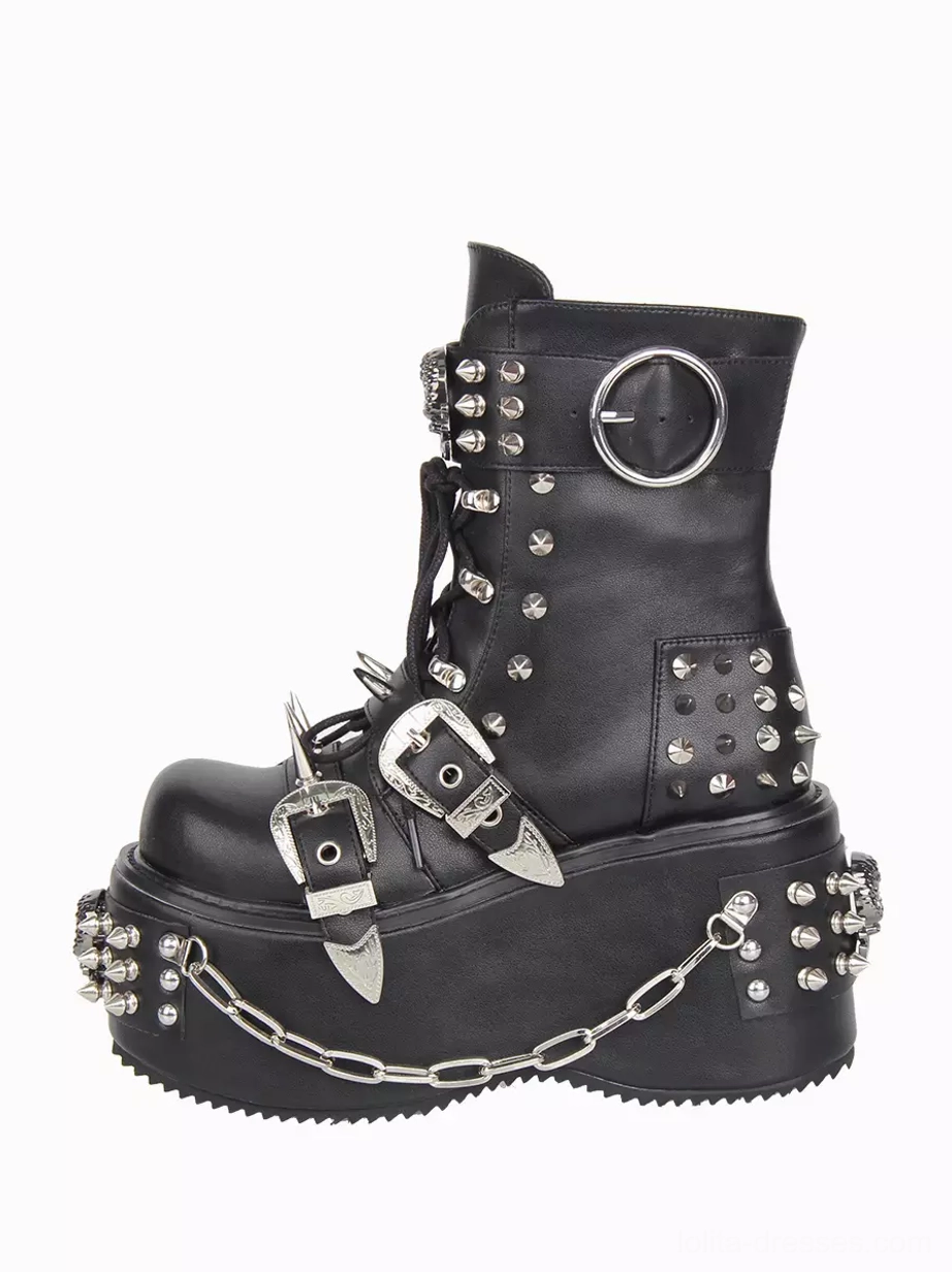 Left rear three-quarter view of Gothic Lolita boot featuring large round buckle on collar, extensive metal studs, spike details, chain trims on vamp, and lace-up closure system