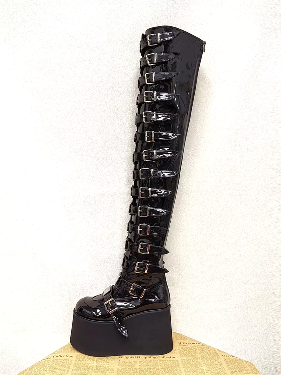 Single left side profile view of gothic lolita platform boot showing ankle buckle strap, glossy patent leather finish, and full-length buckle decorations