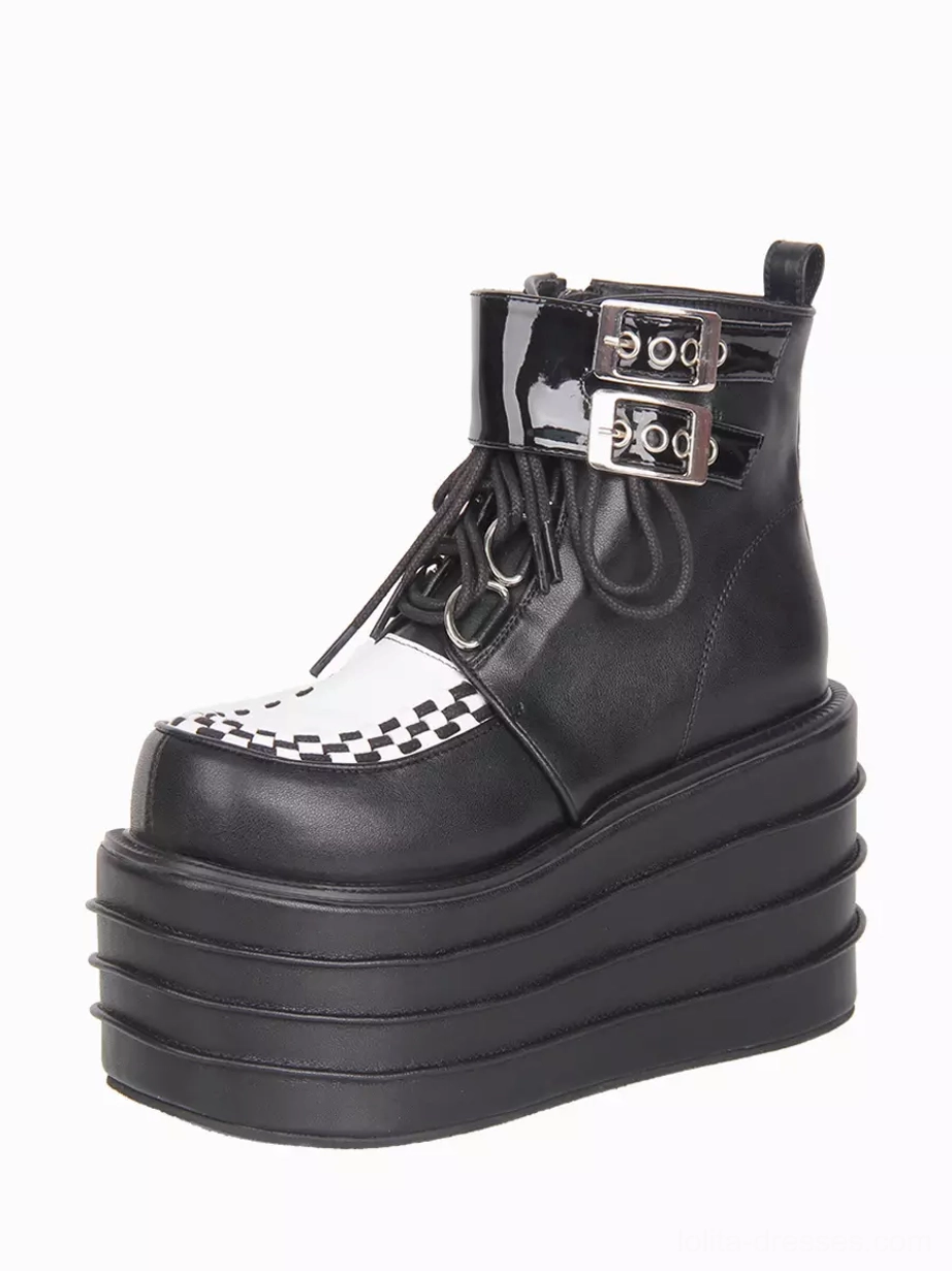 Right front three-quarter view of gothic lolita boot detail with patent leather metal buckles, checkerboard toe decoration, and lace-up design