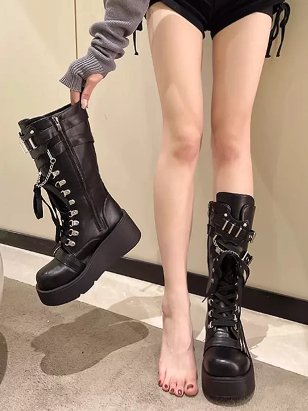 Side display view black gothic lolita mid-calf platform boots side zipper lace-up front metal buckles thick platform sole held by model