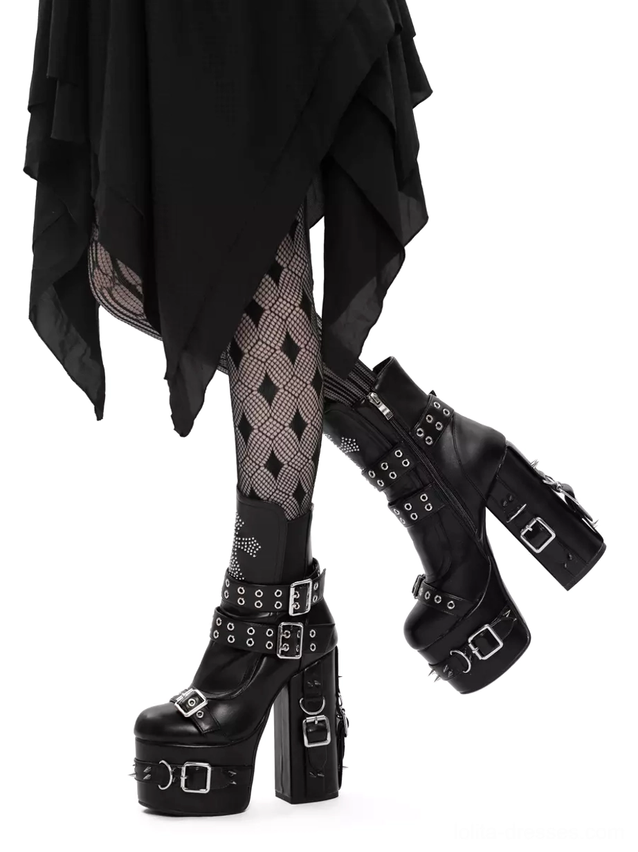 Gothic lolita platform boots on model with crossed legs, front view showing cross ankle decoration and riveted buckle straps