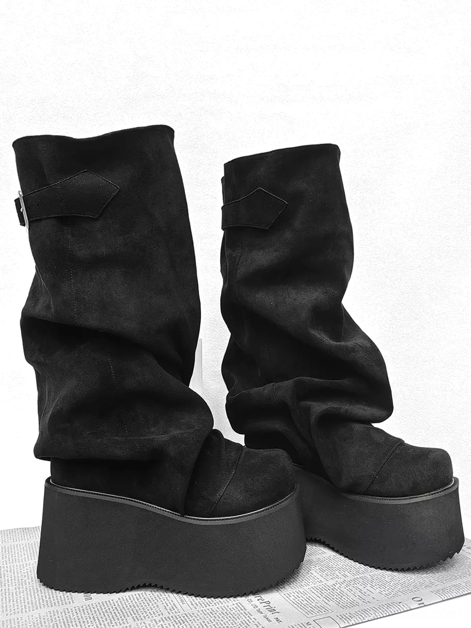 Pair of black slouchy platform mid-calf lolita boots side three-quarter view with adjustable buckle strap, suede-like corduroy texture, and wedge platform heel construction
