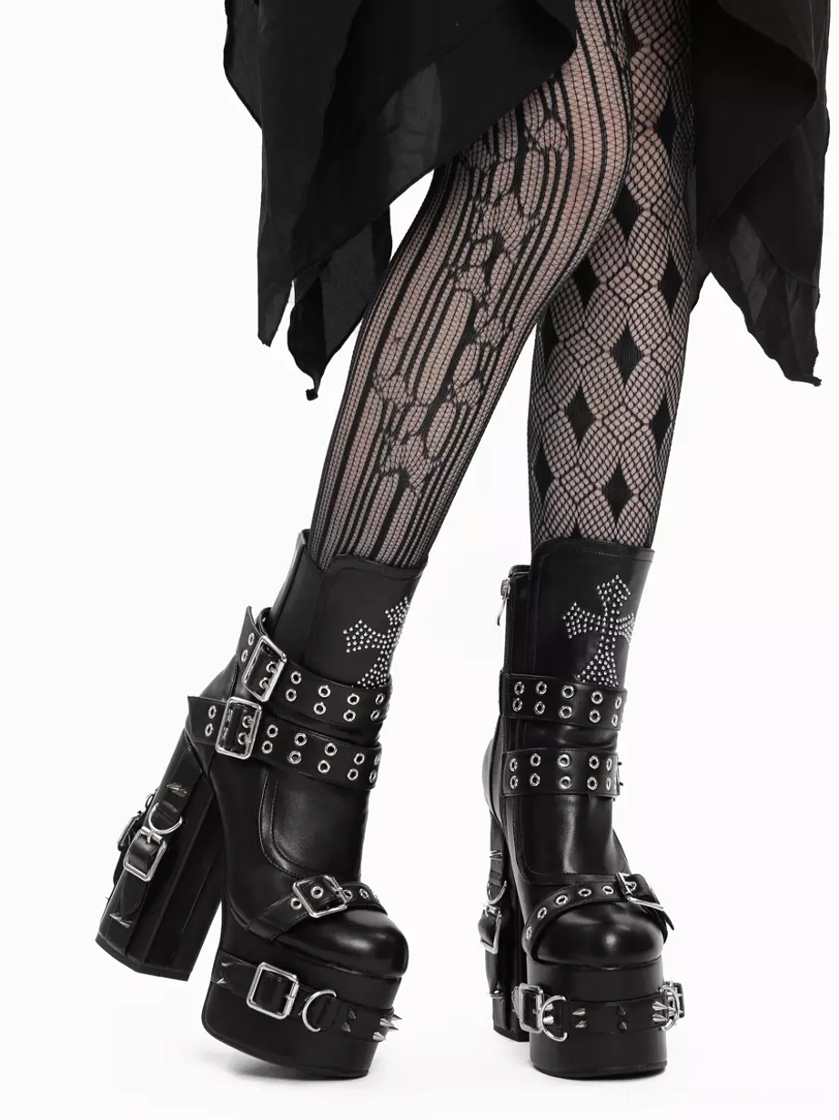 Gothic lolita platform boots rear view on model wearing striped mesh tights and black draped skirt, displaying chunky platform heel and riveted straps