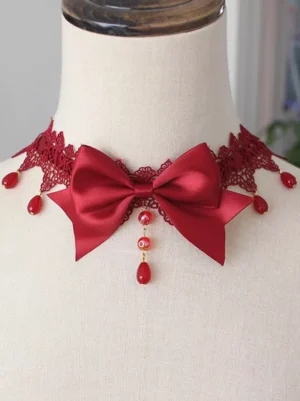 Burgundy red gothic lolita bow choker with red lace trim and red drop bead tassel front close-up on model neck display