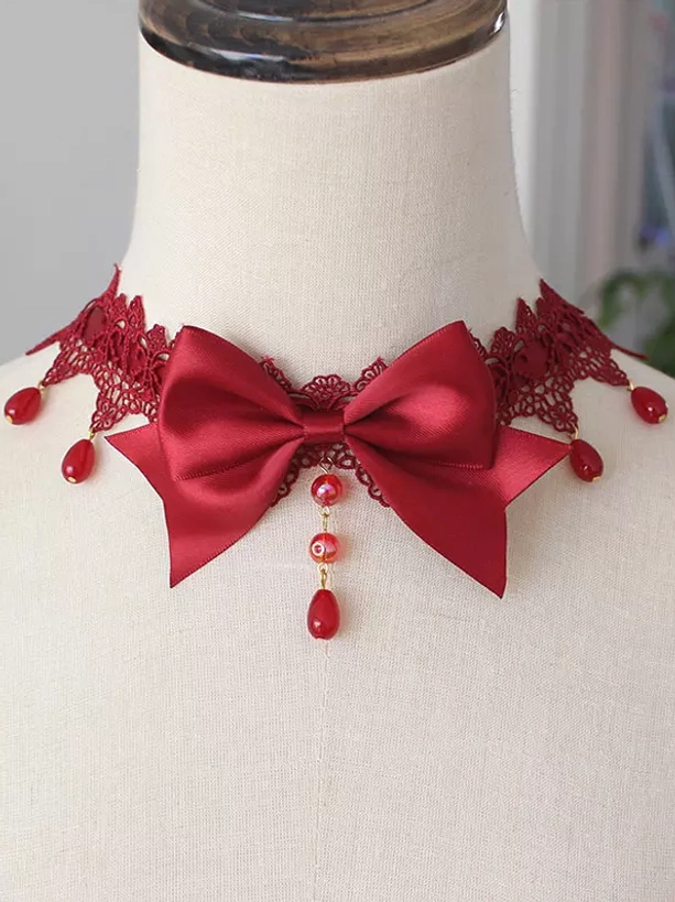 Burgundy red gothic lolita bow choker with red lace trim and red drop bead tassel front close-up on model neck display