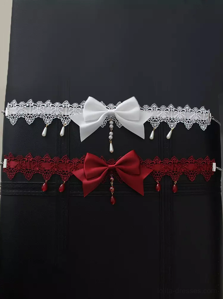 Two matching gothic lolita chokers comparison white and burgundy bow styles flat lay top-down studio view collection