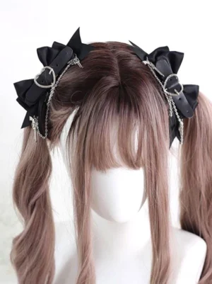 Gothic Lolita bow hair clips front central view on mannequin showing black satin bows, silver metal hardware and delicate chain decorations