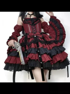 Gothic lolita dress lower half detail showing burgundy black layered ruffled skirt with hanging straps, corset bodice with lace-up front, and puffed ruffled sleeves on female model
