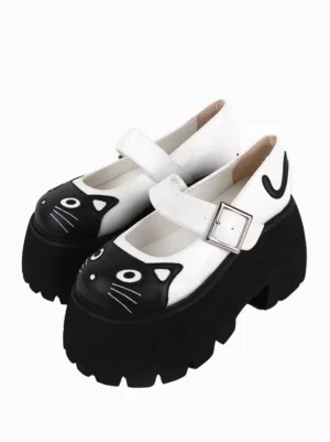 Black cat face Gothic Lolita platform Mary Jane sandal with animal appliqué, front three-quarter view showing black serrated thick outsole and silver square buckle strap on white background