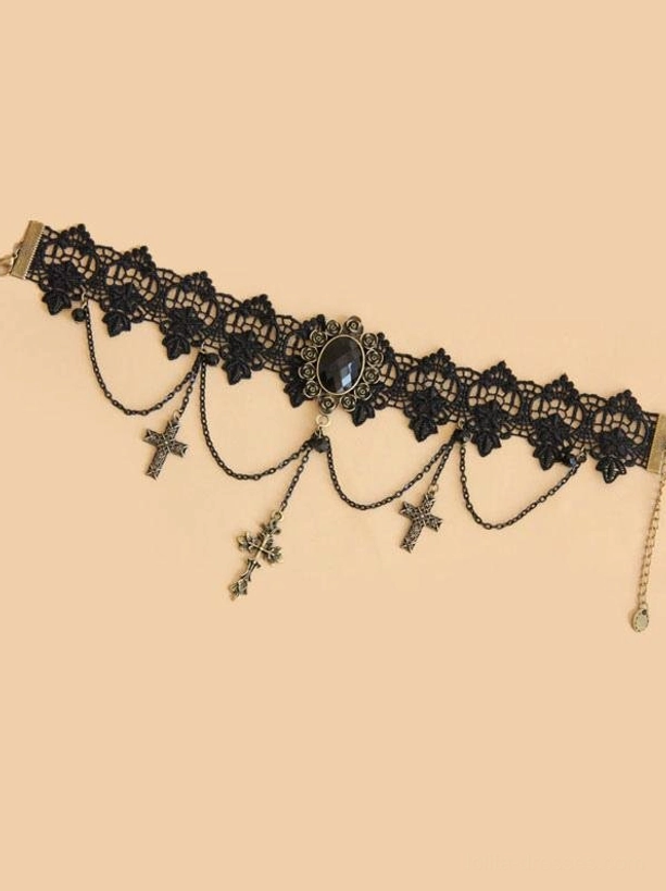 flat lay gothic choker necklace overhead view showing black lace neck collar with central black gem carving multiple bronze cross drop chains and adjustable tail
