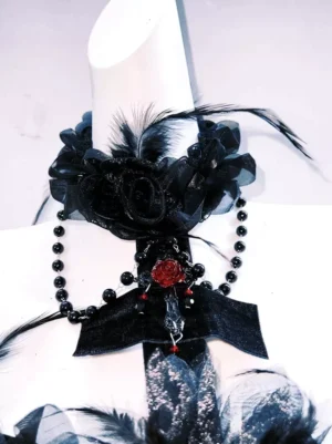 Gothic choker necklace set close-up with black lace roses feather trims crimson rose ornament beaded chain pendant matching dress accessory