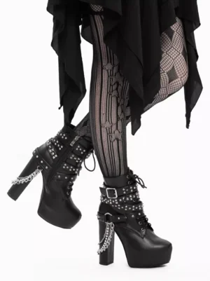 Gothic Lolita chunky heel platform boots side profile view of both feet, featuring studded straps and rear hanging chain, paired with striped fishnet tights and black drape skirt