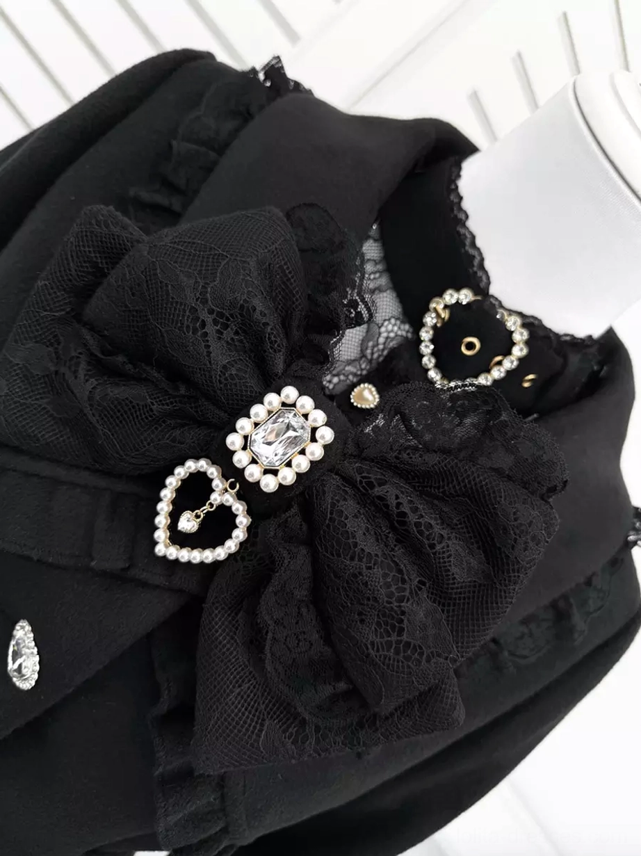 Close-up detail of Gothic Lolita coat collar and cuff with lace bow, diamond heart ornament, and ruffled trim