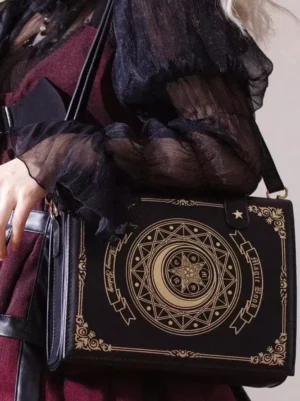 Gothic Lolita coffee brown crossbody bag with golden moon star celestial print, paired with dark frilly Lolita outfit and metal decorative hardware details