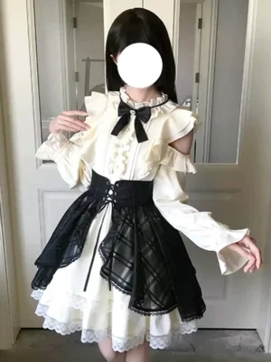 Gothic Lolita cold-shoulder white dress with black plaid overskirt and long puff sleeves in three-quarter front view showcasing corset waist and ruffled shoulder detail