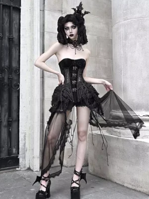 Front three-quarter view of black gothic lolita corset set with boned corset top, lace-up front, vintage metal buckles, cage crinoline structure, and asymmetrical sheer mesh overskirt on model wearing full gothic coordinate