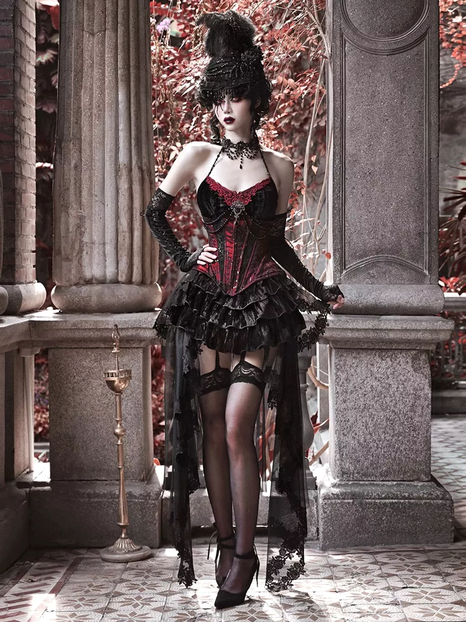 Black gothic lolita corset trumpet skirt set full-body side view with hand on hip ruffled tiered skirt and sheer train detail