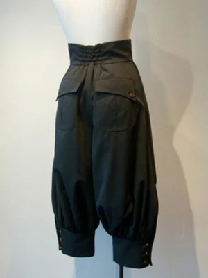 Black gothic lolita cropped pants rear view displaying smocked waist back, two flap back pockets, gathered cropped legs with side button details and tailored construction