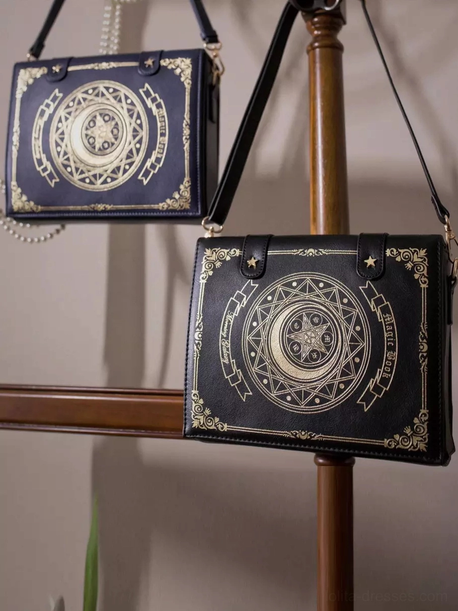 Two color variations of Gothic Lolita crossbody bags displayed on wooden shelf, showing coffee brown and navy blue options with matching golden celestial print