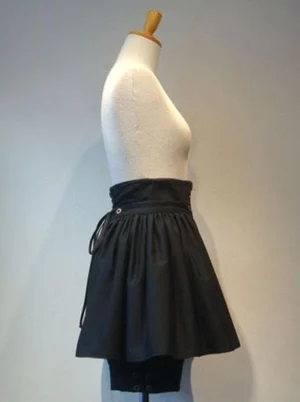 Black gothic lolita culottes left side view showing lace-up ties and architectural pleating with built-in shorts