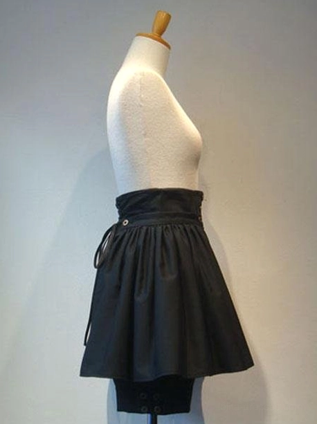 Black gothic lolita culottes left side view showing lace-up ties and architectural pleating with built-in shorts