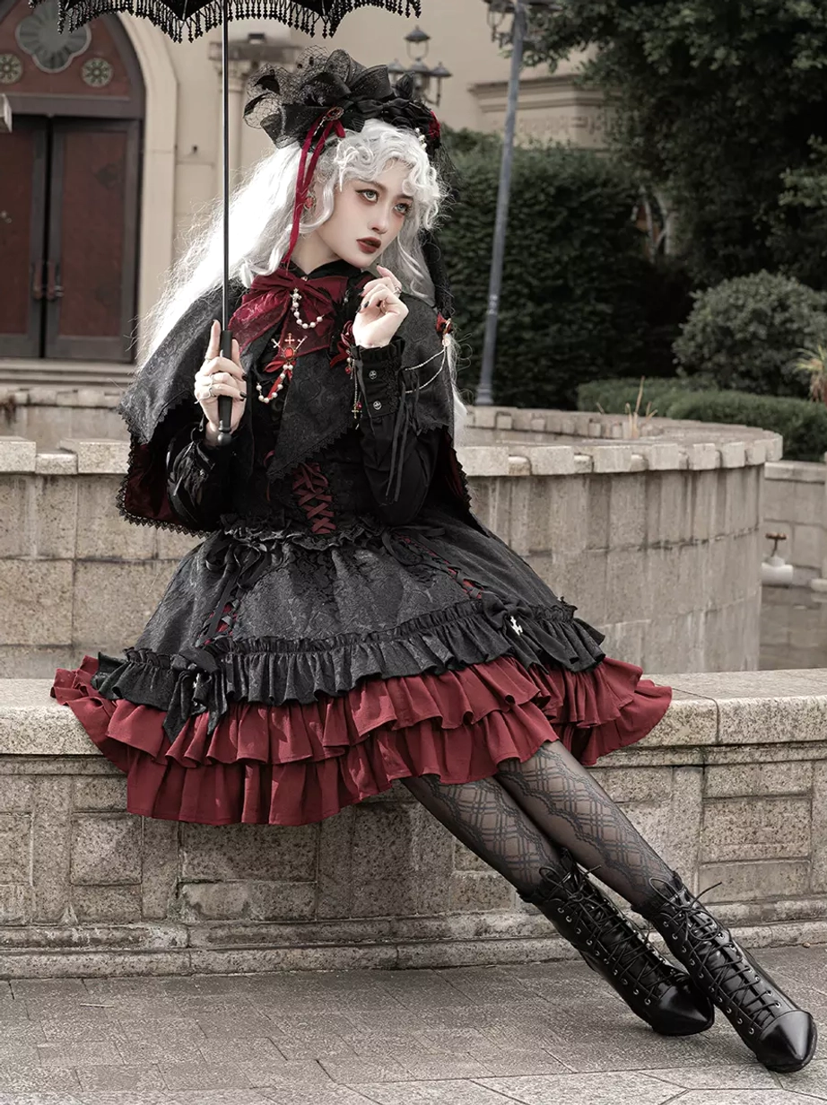 Gothic Lolita dress with lace umbrella accessory, seated three-quarter side outdoor view, fishnet stockings, cross pendant, ruffled skirt layers