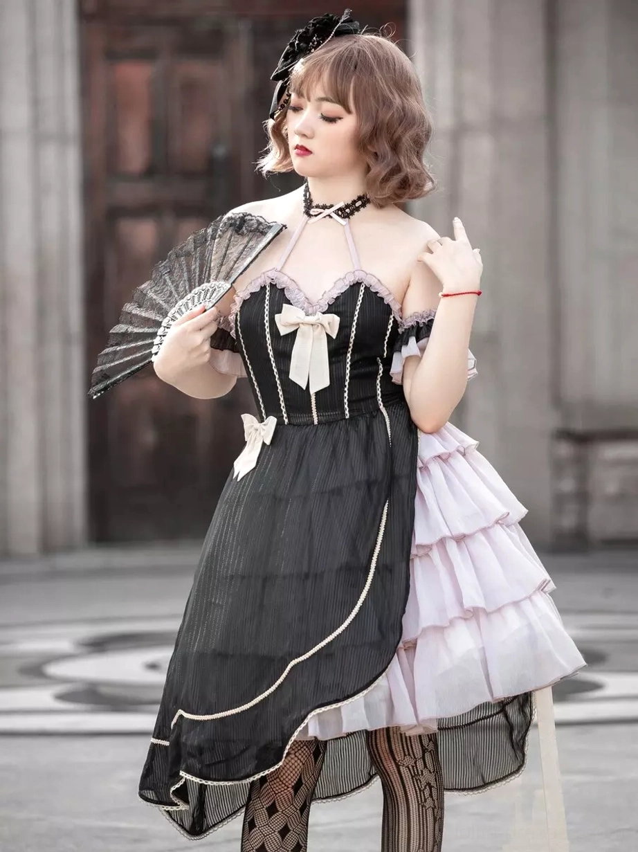 Gothic asymmetrical lolita dress side three-quarter view female model wooden door setting holding folding fan asymmetrical hemline off-shoulder design