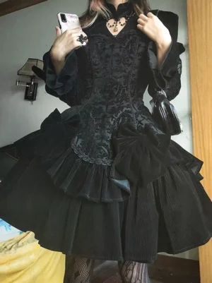 Black gothic lolita dress full-body mirror selfie view with fishnet stockings small black handbag alternative fashion styling