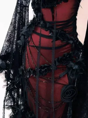 Close-up detail of gothic lolita dress showing black lace bell sleeve with beaded chain trim sheer mesh fabric and floral embellishments