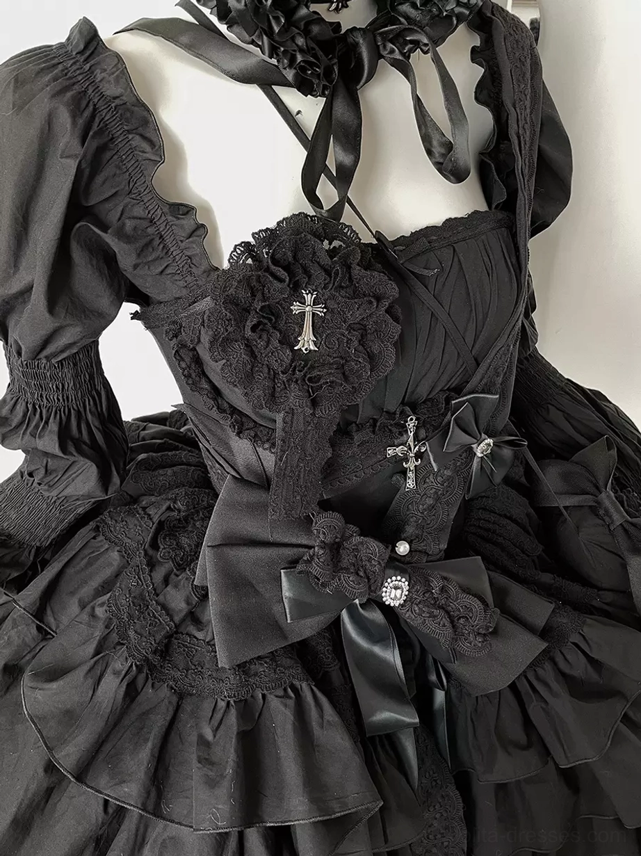 Close-up detail of black Gothic Lolita dress bodice featuring square neckline with choker, large satin bows, cross embellishments, intricate ruffle fabric texture, and premium construction quality