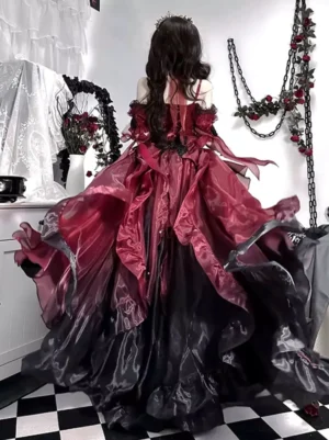 Gothic Lolita dress back view showing flowing long train with layered organza skirt, off-shoulder sleeves and elaborate ruffled details